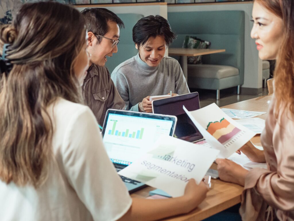 Professional team meeting focused on evaluating business solutions, reviewing performance reports, and discussing digital growth strategies. The collaborative setting reflects the importance of selecting the right PSG pre-approved vendor in Singapore, where businesses assess expertise, service offerings, and project outcomes before making an informed decision.